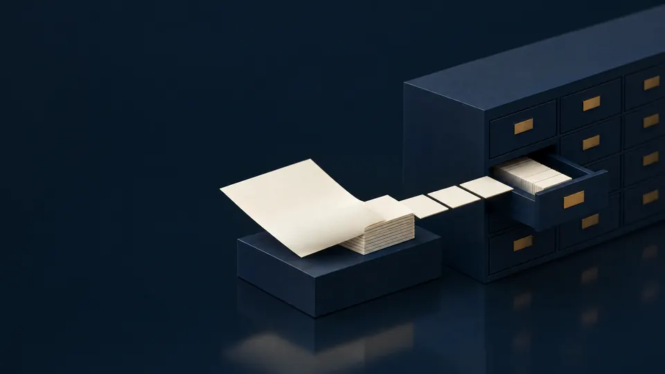 Miniature model: a sheet of paper unfolds into a line of tiles that slide into the drawer of a navy cabinet.